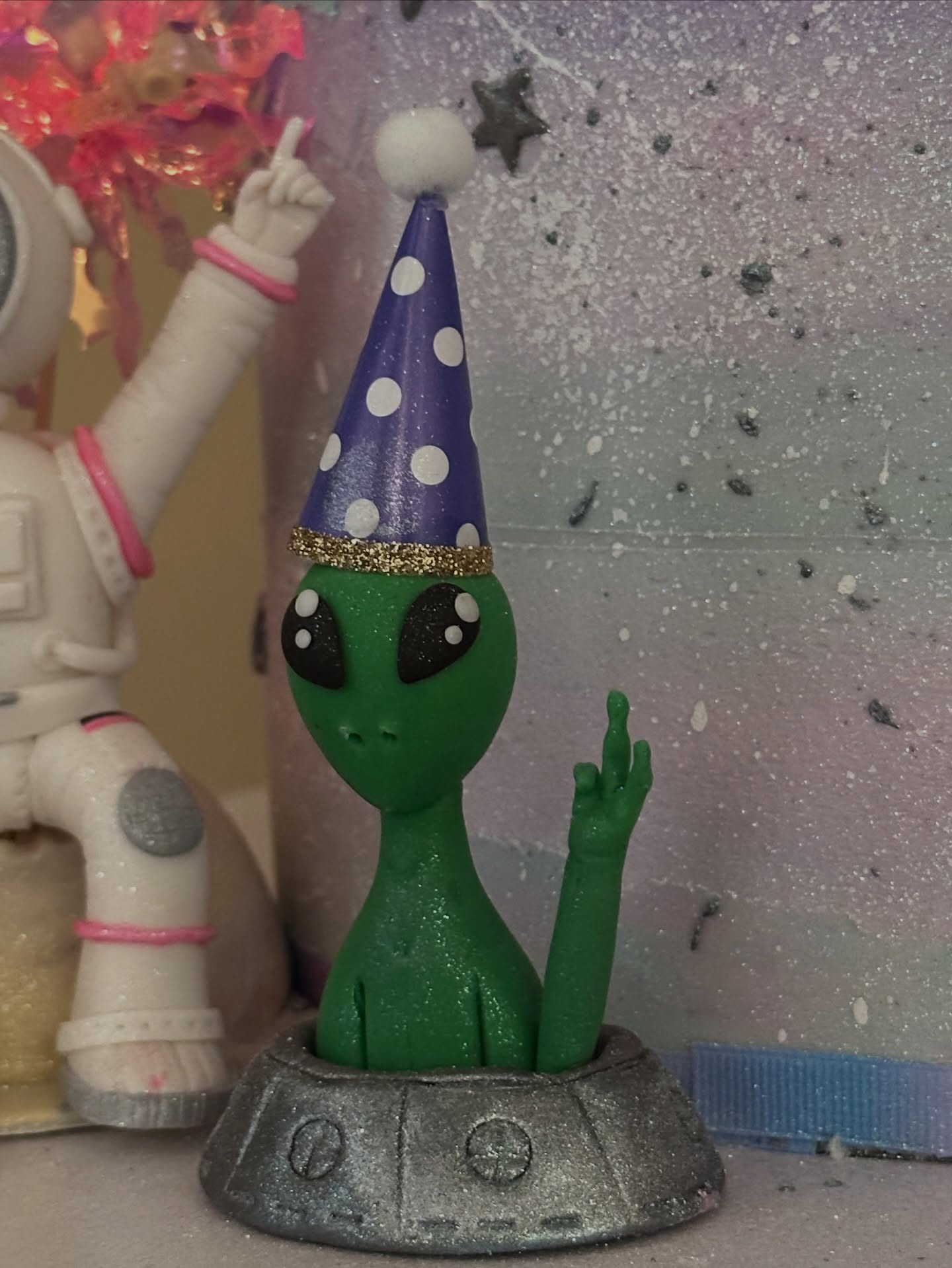 Hand-sculpted alien figurine detail from space birthday cake